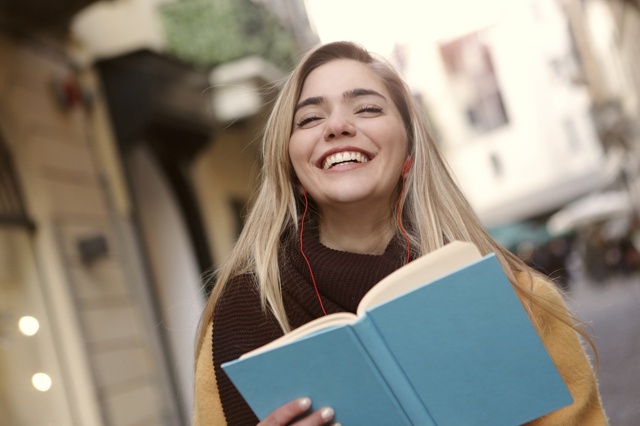 Woman reading Bible and smiling