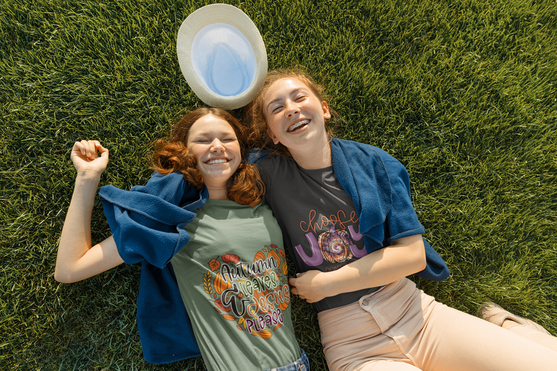 Two friends laying in the grass laughing
